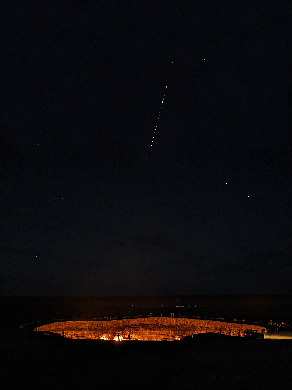 The Gates of Hell (Darwaza, Turkmenistan) - at night with satellites in the sky